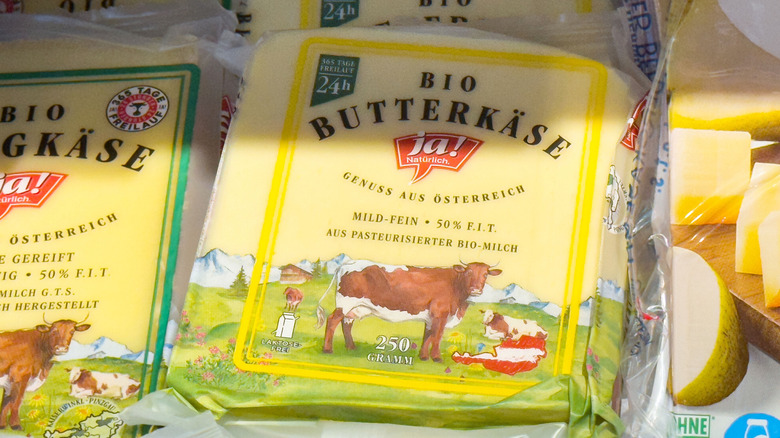 A package of butterkase cheese in refrigerated display.