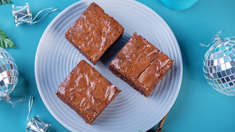 Brownie fudge on a blue plate surrounded by mini disco balls