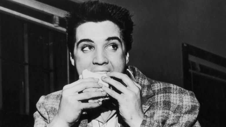 black and white photo of young Elvis eating