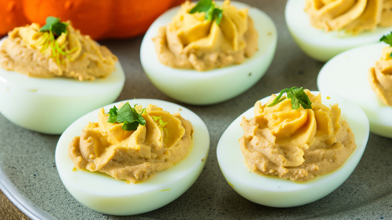 A plate of six garnished deviled eggs