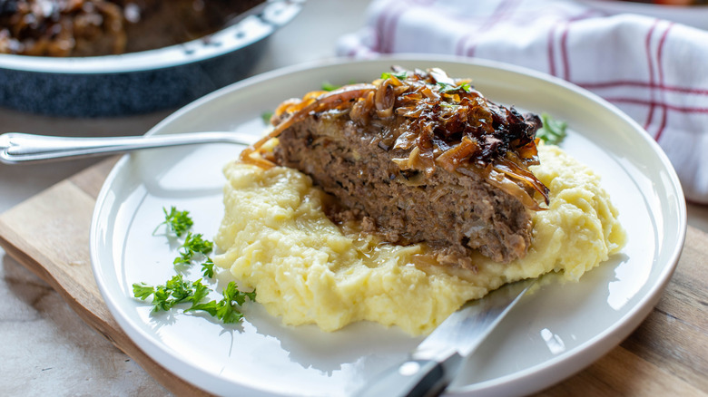 Meatloaf with cabbage and mashed potatoes on a plate.