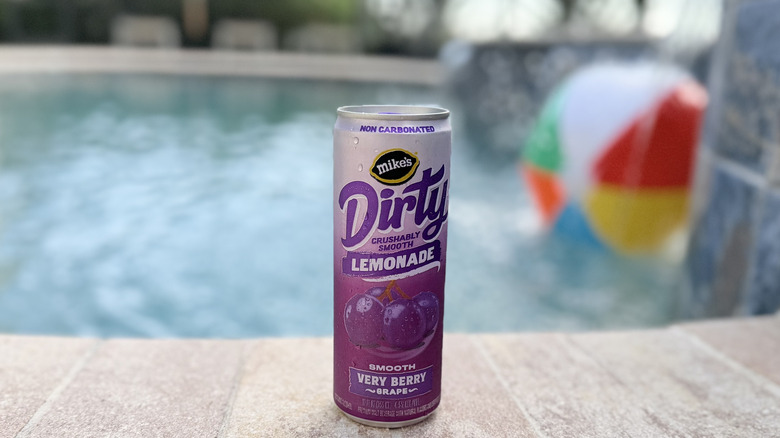 Can of Mike's Dirty Lemonade in Very Berry Grape flavor beside the pool