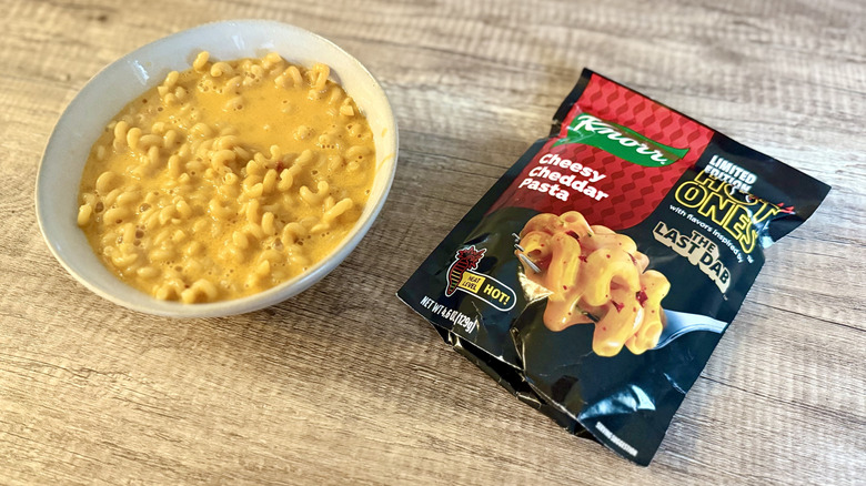 Knorr Cheesy Cheddar Pasta in a bowl next to the packet