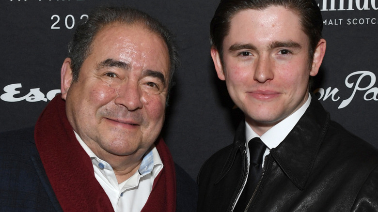 Emeril Lagasse and his son E.J. Lagasse smile on a red carpet at an event