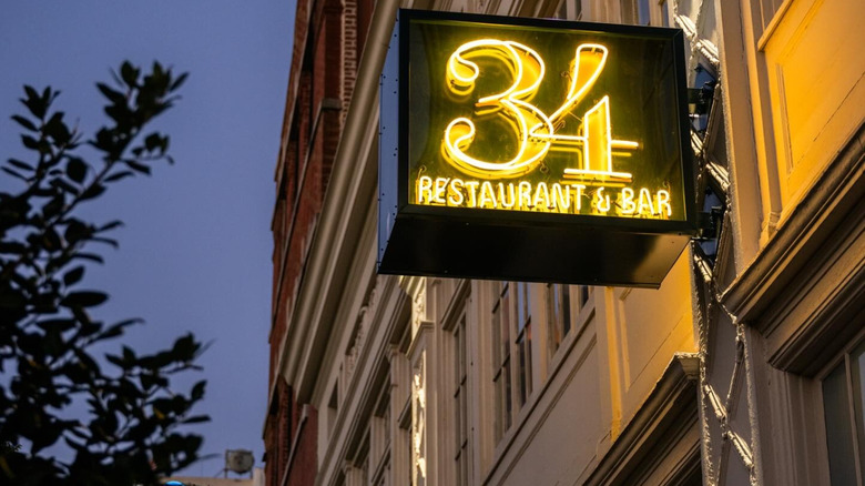 Illuminated neon signage outside 34 Restaurant & Bar in New Orleans