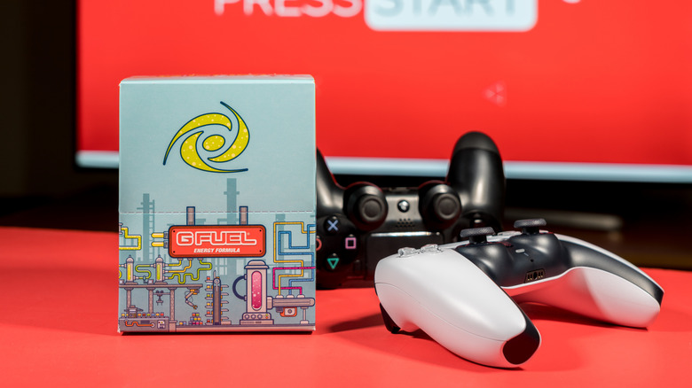 GFuel energy drink next to PS5 controllers