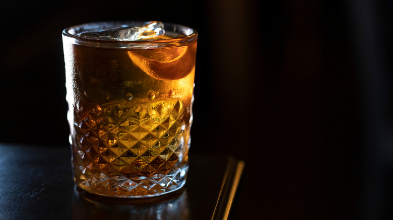 Rusty Nail cocktail on a dark bar