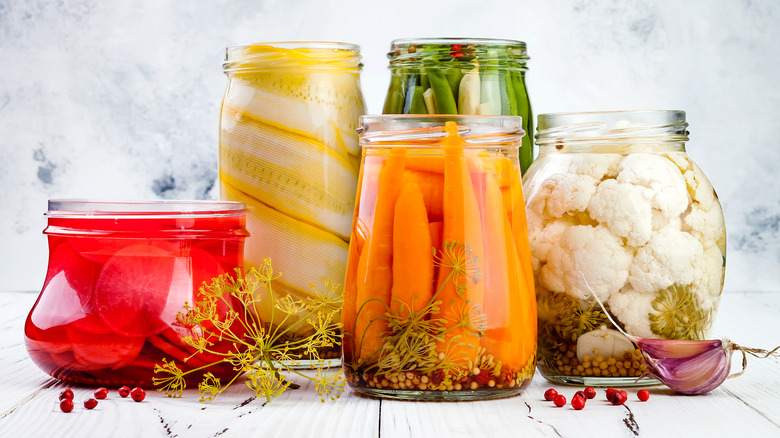 Assorted pickled vegetables in glass jars
