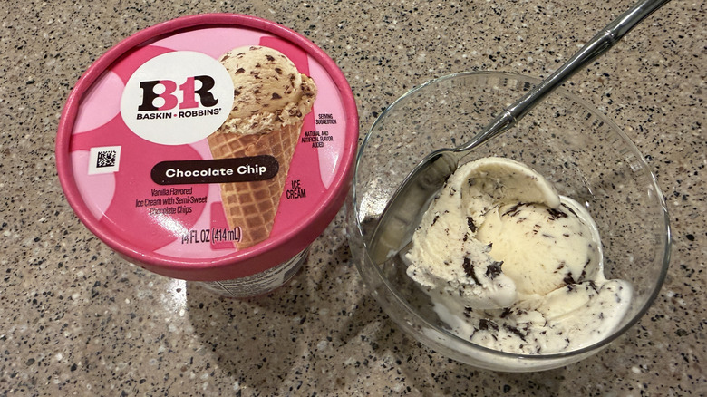Baskin Robbins pint of Chocolate Chip with a scoop in a glass bowl with a spoon