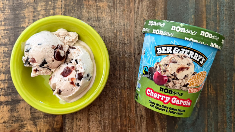 Two scoops of Ben & Jerry's Cherry Garcia non-dairy ice cream next to a pint