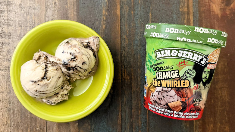 Two scoops of Ben & Jerry's Change the Whirled non-dairy ice cream next to a pint