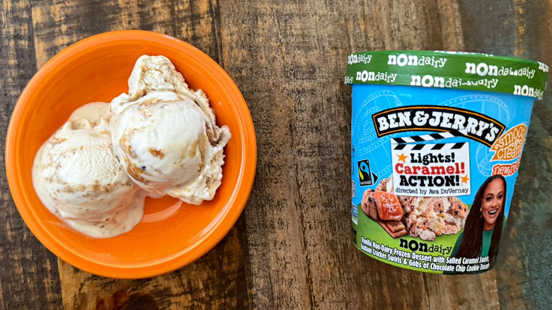 Two scoops of Ben & Jerry's Lights! Caramel! Action! non-dairy ice cream next to a pint