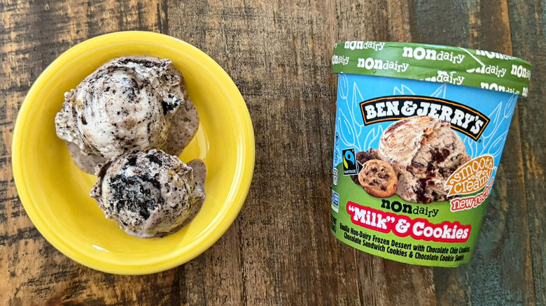 Two scoops of Ben & Jerry's "Milk" & Cookies non-dairy ice cream next to a pint