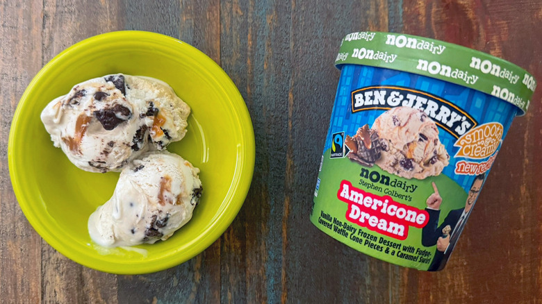 Two scoops of Ben & Jerry's Americone Dream non-dairy ice cream next to a pint