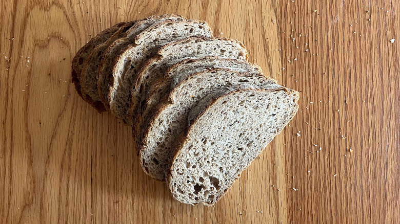 A loaf of rye bread is cut into slices