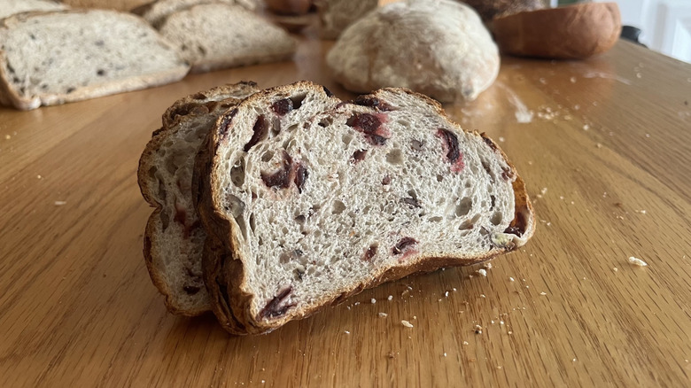 A loaf of bread is flecked with cranberries