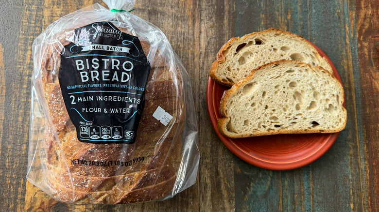 Aldi Specially Selected Bistro Bread in its packaging next to two slices on a plate