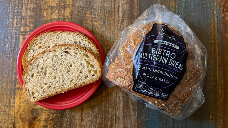Aldi Specially Selected Bistro Multigrain Bread in its packaging next to a plate with two slices
