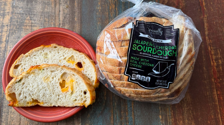 Aldi Specially Selected Jalapeno Cheddar Sourdough in its packaging next to a plate with two slices