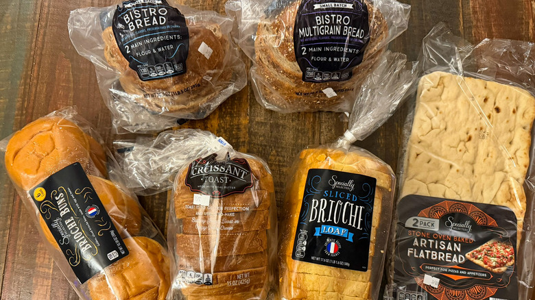 Aldi Specially Selected breads in their packaging on a wood table, ready for ranking