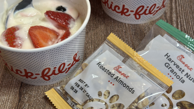 Cup of Chick-fil-A Berry Parfait with roasted almonds & Harvest Nut granola packets