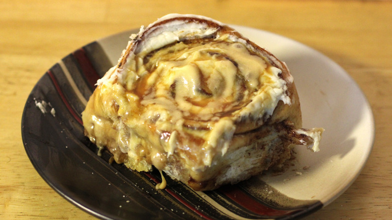 A Cinnabon Caramel Lover Topped Bon on a plate