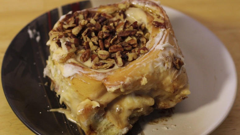 A Cinnabon Caramel PecanBon on a plate