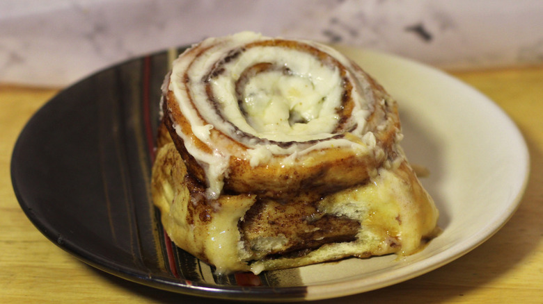 A Cinnabon Classic roll on a plate