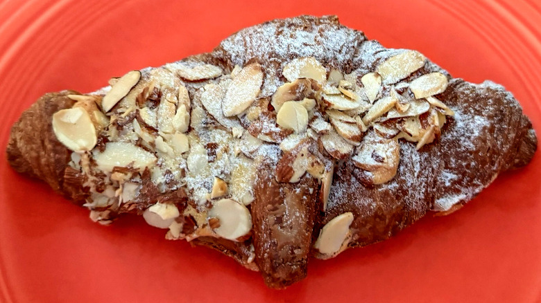 an almond Croissant from Paris Baguette on plate