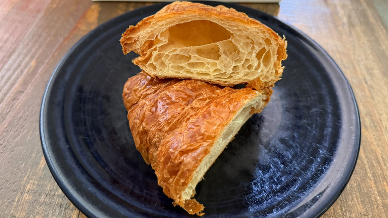 A croissant from Paris Baguette split open on plate