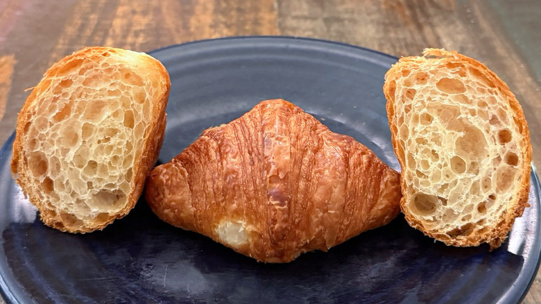Two mini croissants from Paris Baguette on plate, one croissant split open