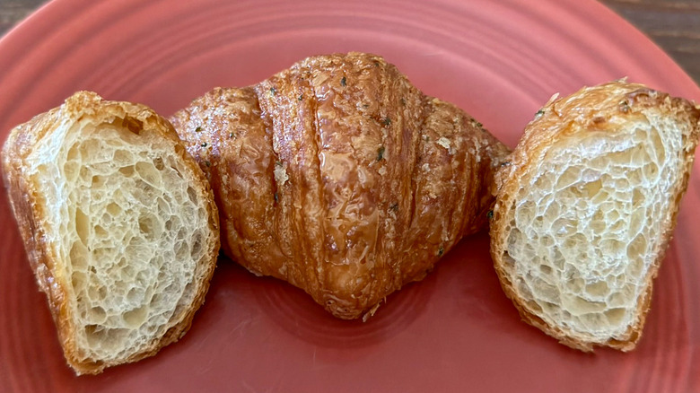 Two Mini Garlic Croissants from Paris Baguette on plate, one split open