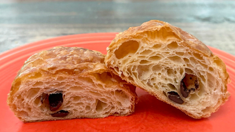 A pain au chocolat split open from Paris Baguette on plate