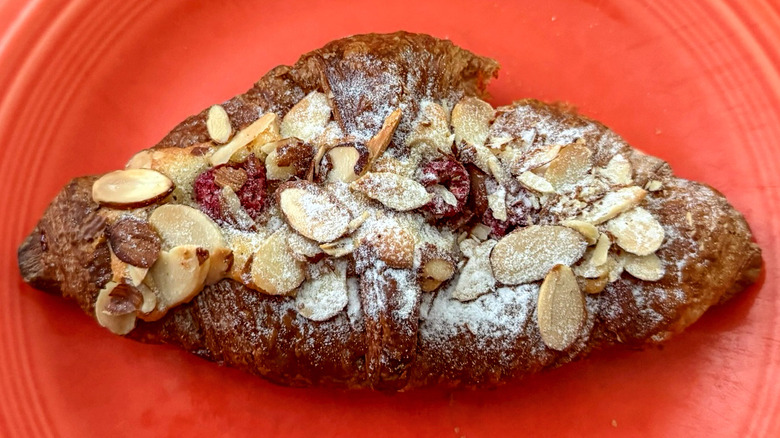 A raspberry almond Croissant from Paris Baguette on plate