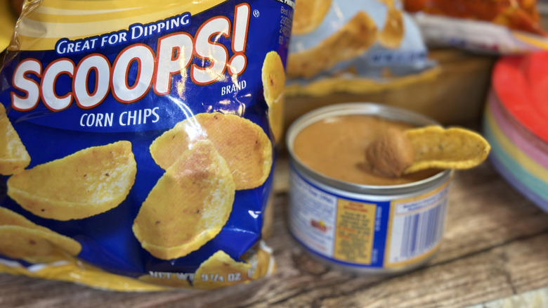 Fritos Scoops bag with one chip scooping in bean dip