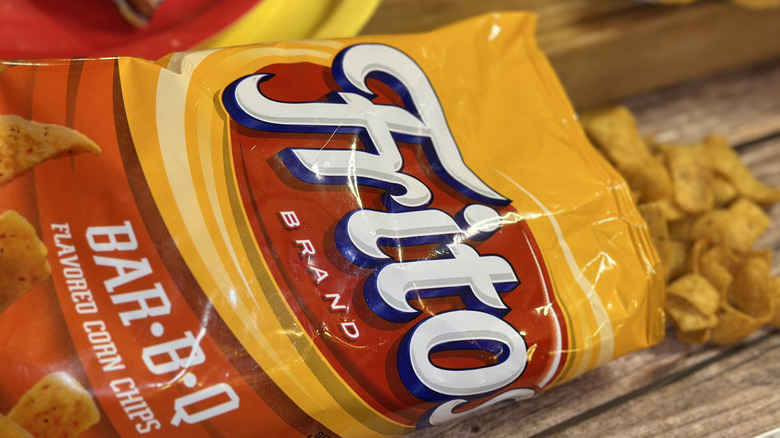 Fritos BAR-B-Q bag with fritos spilling out on a wooden surface