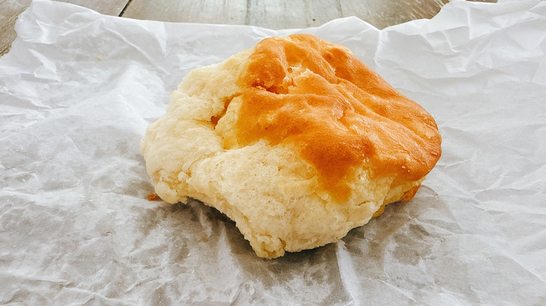 KFC Biscuit on wax paper on wooden table