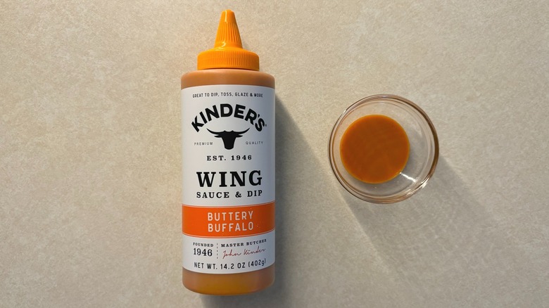 Kinder's Buttery Buffalo Wing Sauce and Dip bottle and sauce in glass ramekin