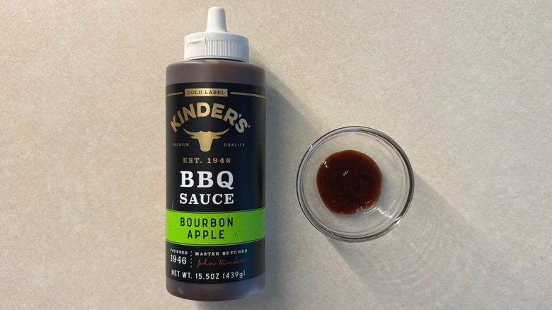 Kinder's Gold Label Bourbon Apple BBQ Sauce bottle and sauce in glass ramekin