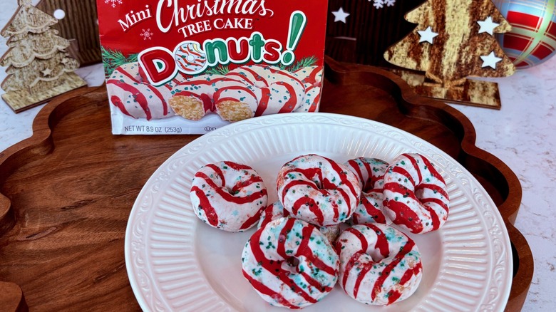 A plate full of Little Debbie mini Christmas tree cake donuts