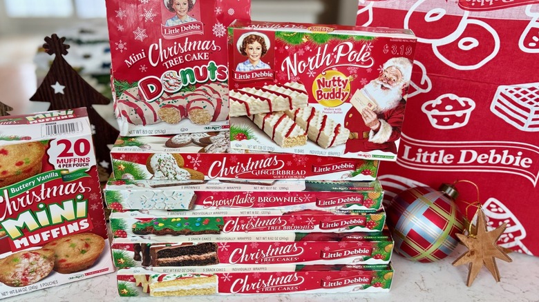 A stack of Little Debbie Christmas snack cakes, donuts, and muffins