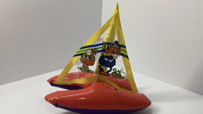 An inflatable toy boat featuring McDonald's branding, colors, and characters