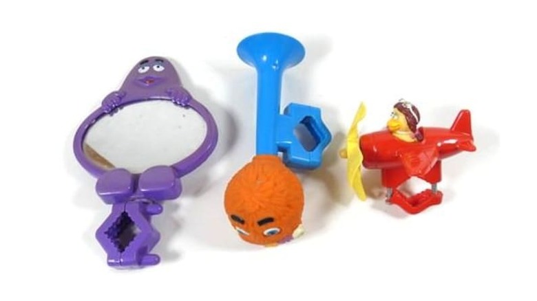 Three McDonald's themed bike accessories, including a purple Grimace mirror