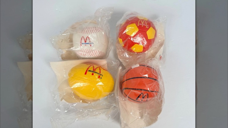 Four small McDonald's branded balls of various kinds, all in their packaging