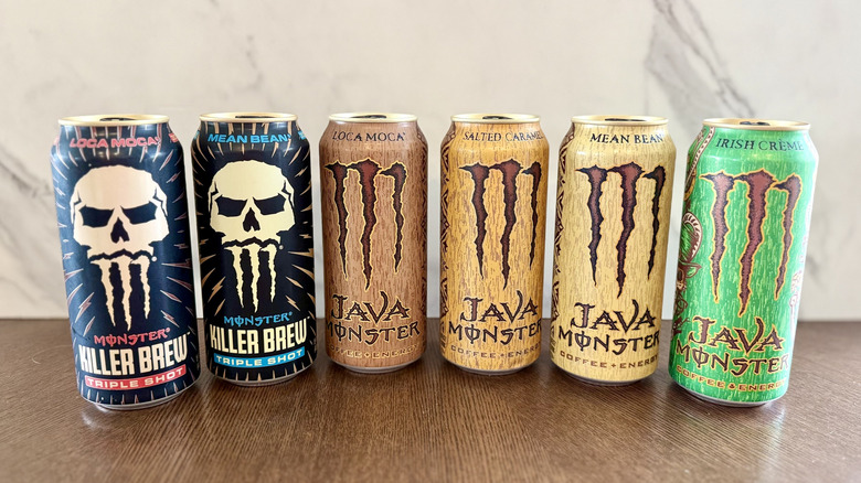Six Monster Java cans lined up on a table