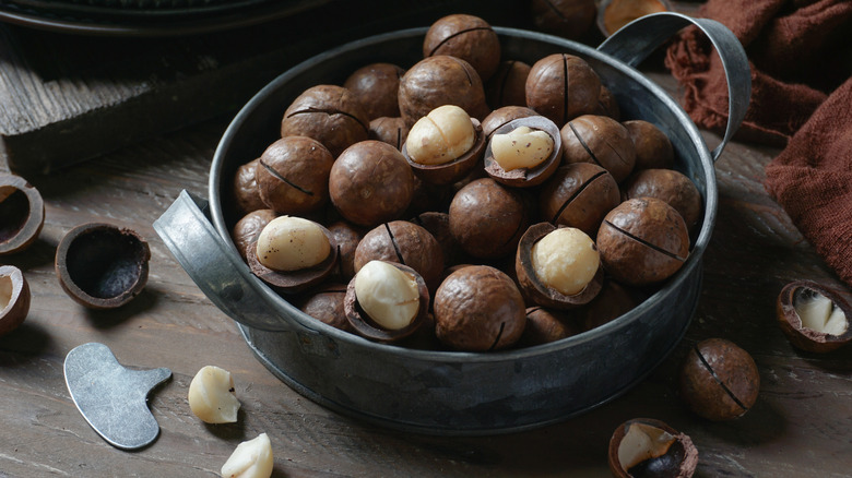 Macademia nuts in rustic black bowl