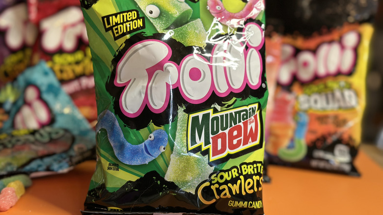 Close up of Trolli Mountain Dew Sour Brite Crawlers with other Trolli brands faded in background
