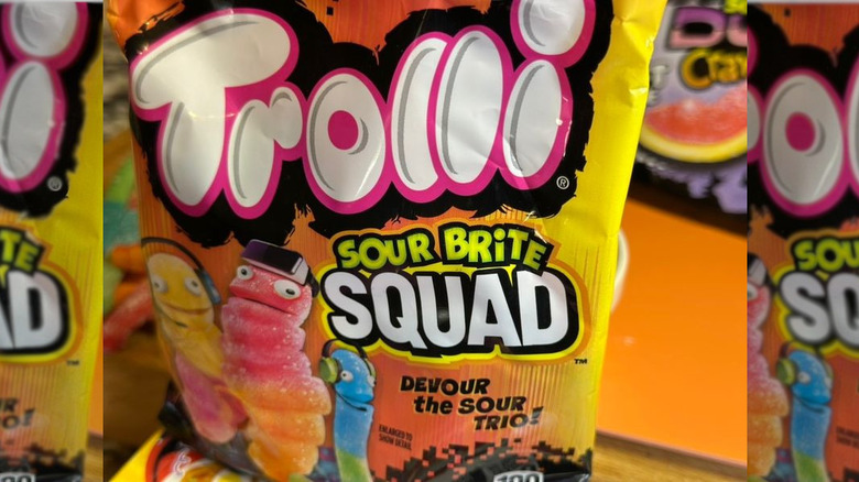 Close up of Trolli Sour Brite Squad package with crochet bird in background