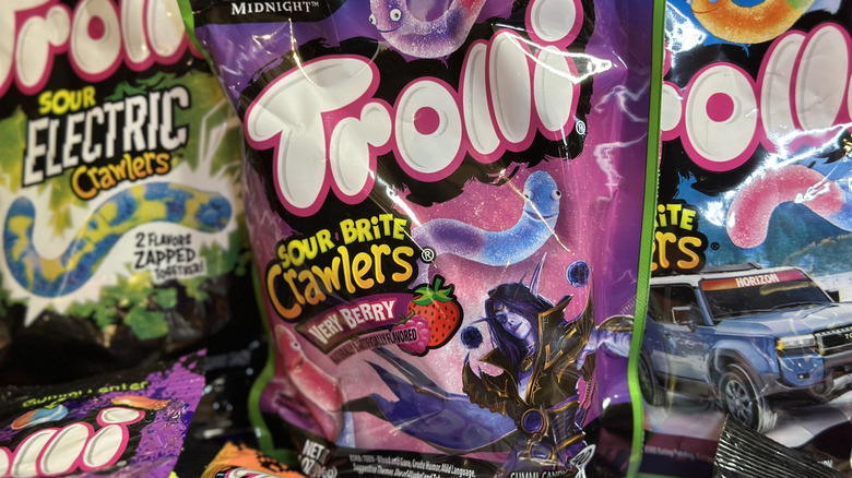 Close up of Trolli Sour Brite Crawlers Very Berry with other Trolli candies in background