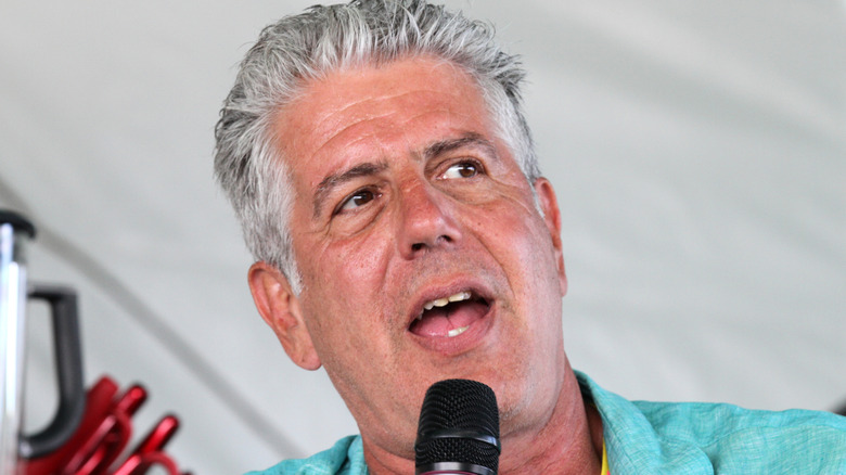chef Anthony Bourdain speaking into microphone